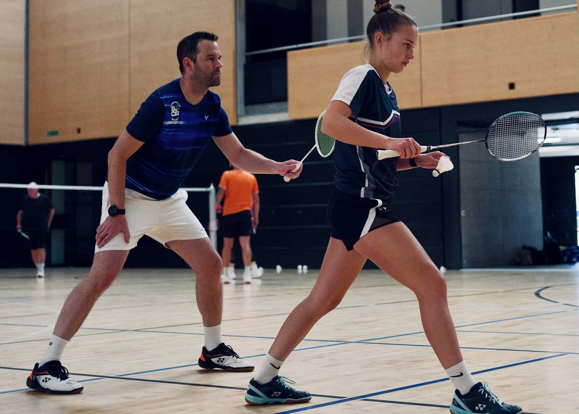 Mixed doubles, two players ready to receive